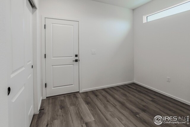 unfurnished room with dark hardwood / wood-style floors