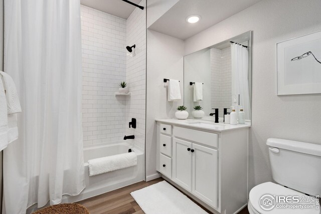 full bathroom featuring vanity, toilet, hardwood / wood-style floors, and shower / bath combo