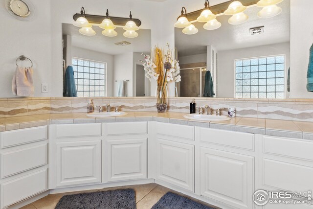 bathroom featuring vanity, an enclosed shower, and tile patterned floors