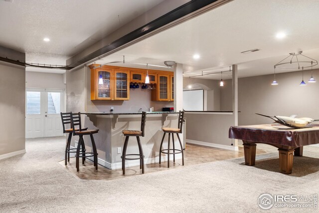 kitchen featuring pendant lighting, light colored carpet, and billiards