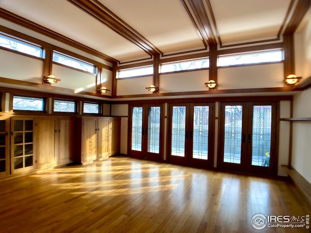 interior space with plenty of natural light, light hardwood / wood-style floors, and french doors