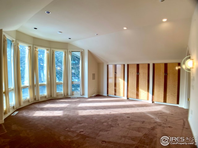 bonus room featuring lofted ceiling and light carpet