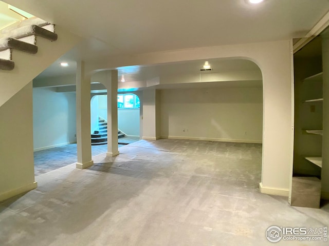 basement featuring light colored carpet