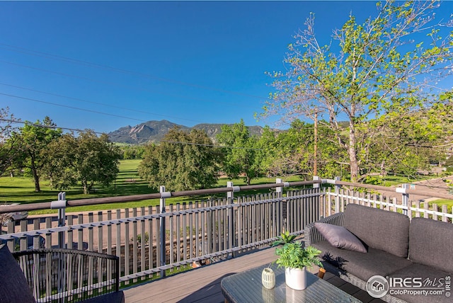 wooden deck featuring a mountain view and outdoor lounge area