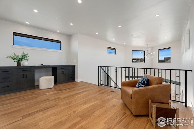 sitting room with a chandelier, light wood-type flooring, and recessed lighting