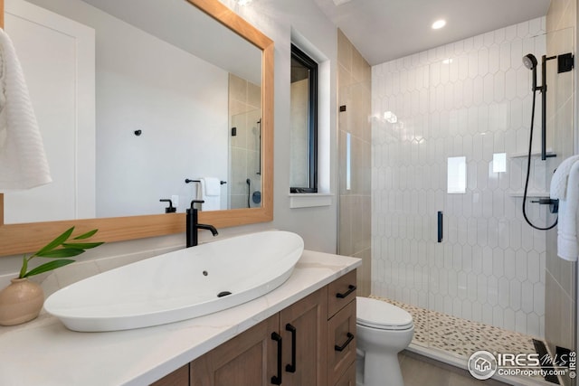 bathroom with toilet, recessed lighting, a shower stall, and vanity