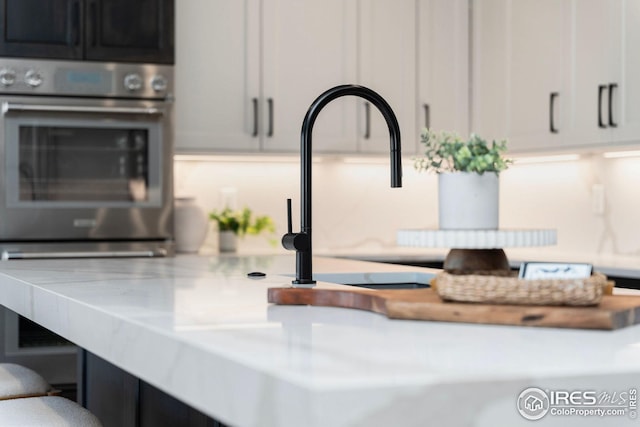 details featuring light countertops and stainless steel oven
