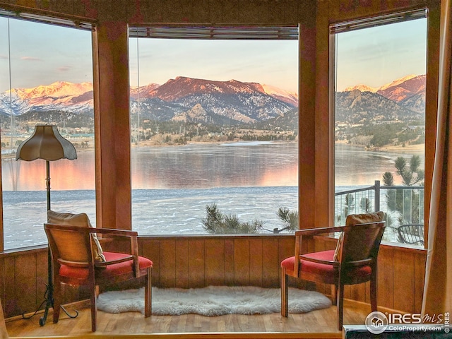 interior space with a water and mountain view and a wealth of natural light