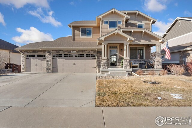 craftsman-style house with a garage, stone siding, a porch, and concrete driveway