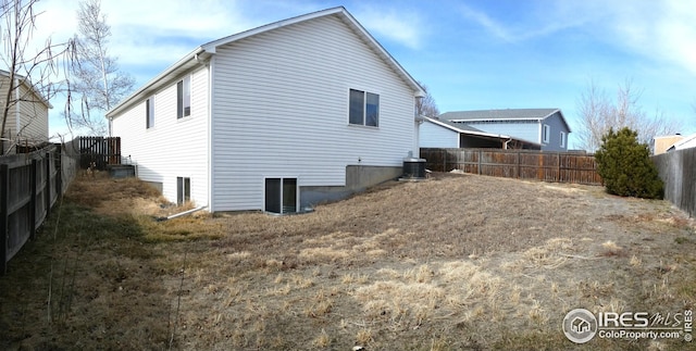 view of side of home with central AC unit