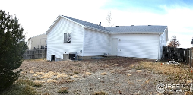 back of house featuring cooling unit