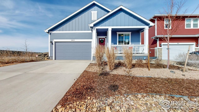 craftsman-style home with board and batten siding, a porch, an attached garage, and concrete driveway