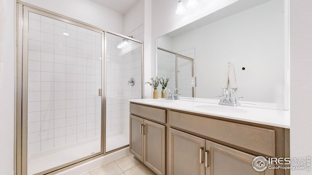 full bath featuring a sink, double vanity, and a stall shower