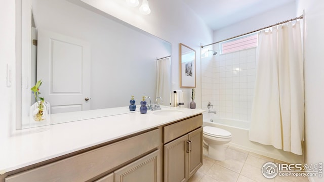 bathroom with tile patterned floors, shower / bath combo with shower curtain, vanity, and toilet