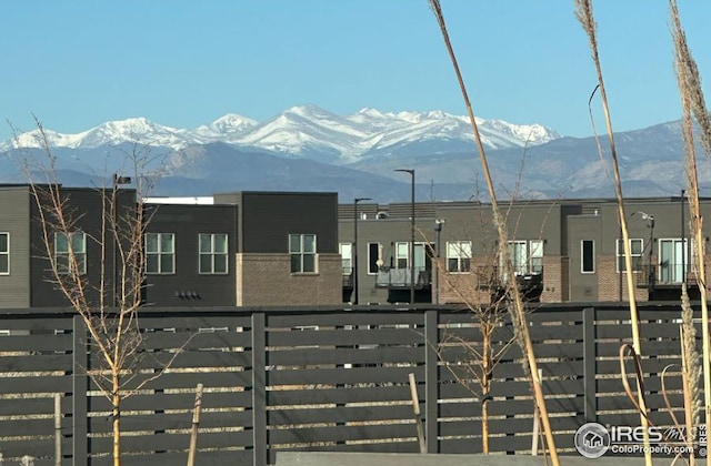 exterior space featuring fence and a mountain view
