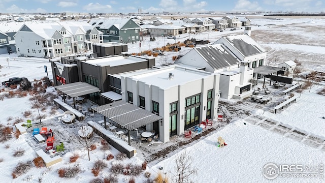 snowy aerial view featuring a residential view