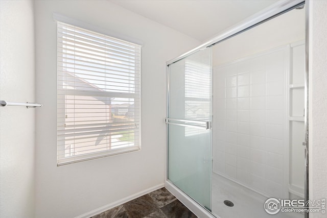 bathroom featuring a shower with shower door