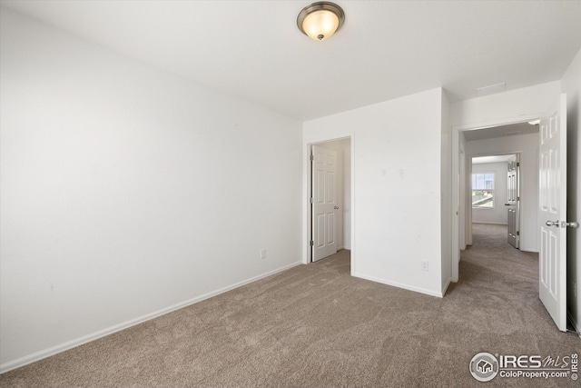 unfurnished bedroom featuring light colored carpet