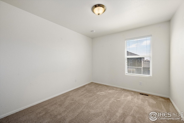 empty room with light colored carpet