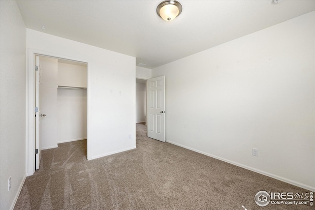 unfurnished bedroom featuring a closet and carpet