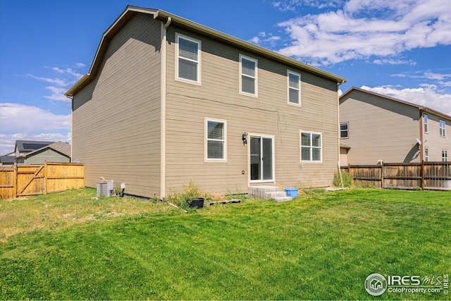 rear view of property with a lawn