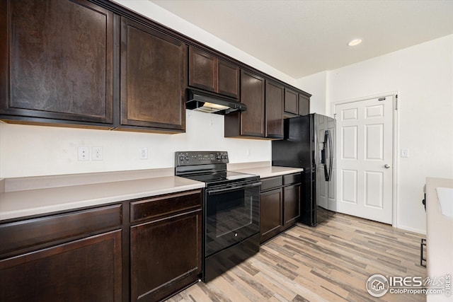 kitchen with light hardwood / wood-style floors, dark brown cabinetry, and black appliances