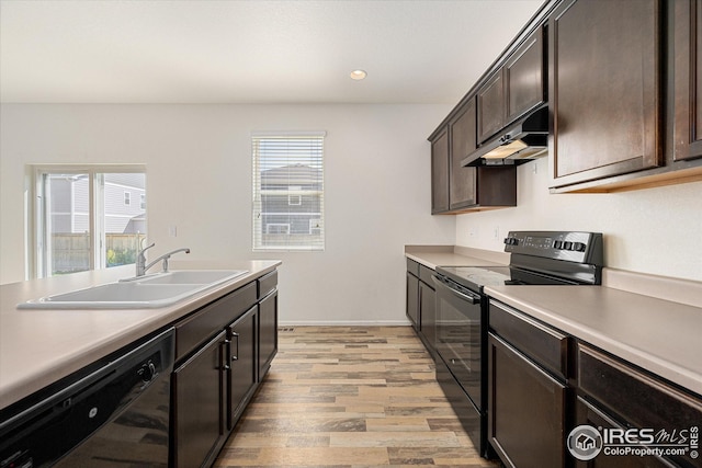 kitchen featuring light hardwood / wood-style flooring, sink, dark brown cabinets, and black appliances