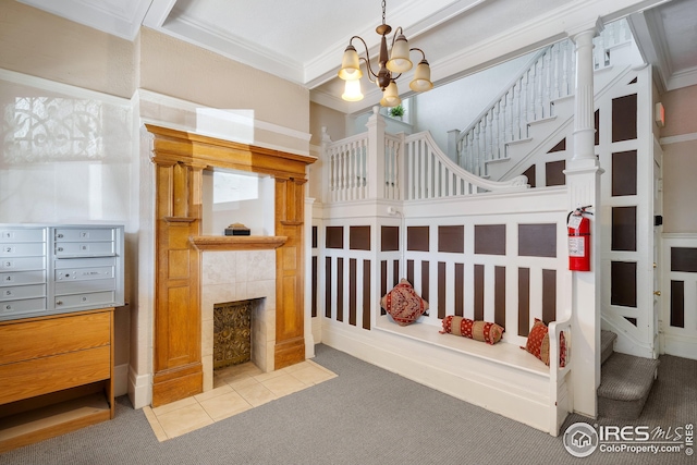 carpeted bedroom with an inviting chandelier, ornamental molding, and a fireplace