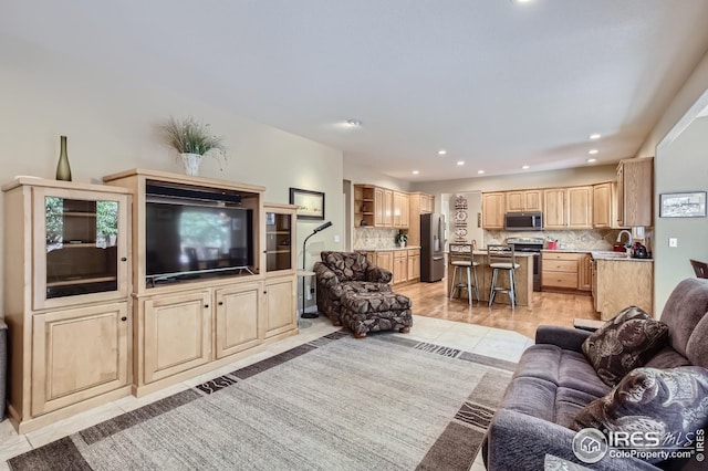 living room featuring light tile patterned flooring and sink