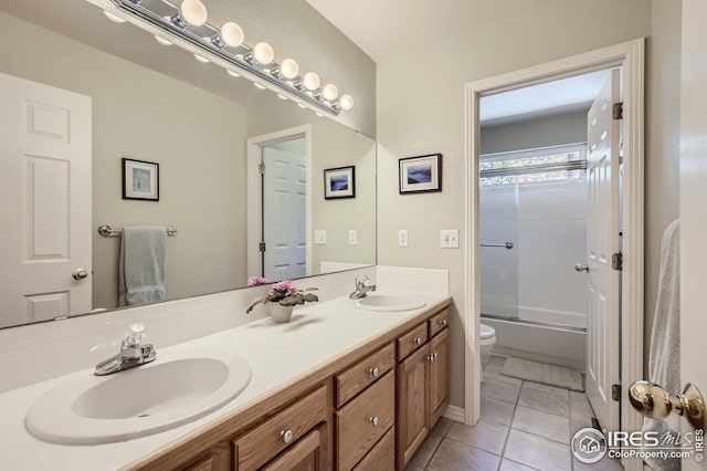 full bathroom with vanity, bath / shower combo with glass door, tile patterned floors, and toilet