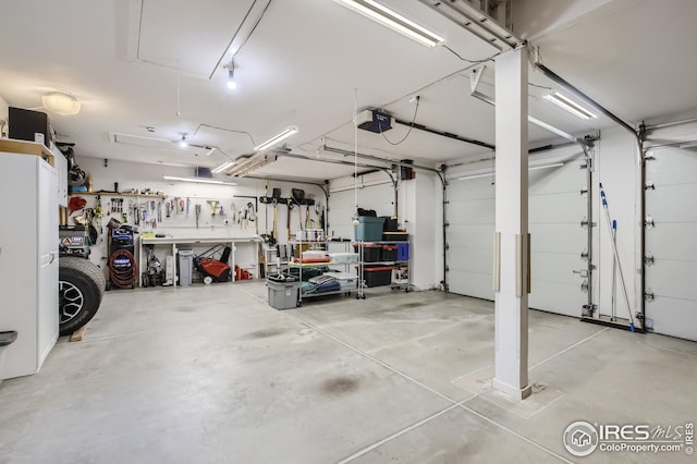 garage with a garage door opener and a workshop area