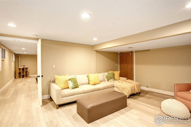 living area with baseboards, light wood-type flooring, and recessed lighting