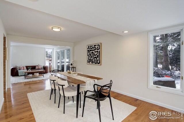 dining room with baseboards, recessed lighting, and light wood-type flooring