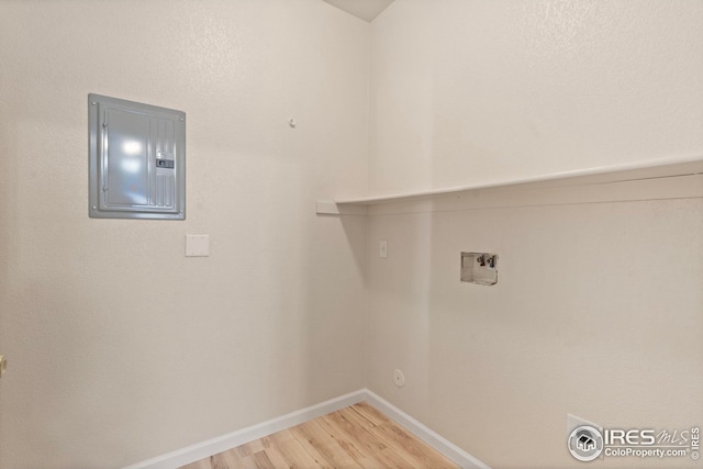 laundry room featuring hookup for a gas dryer, hookup for a washing machine, wood-type flooring, and electric panel