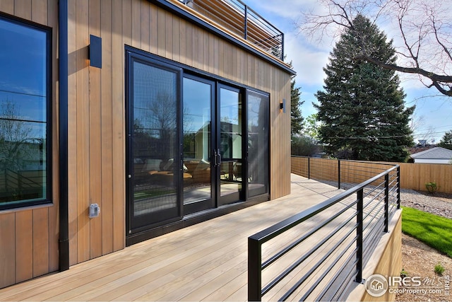 back of house with a balcony and a lawn