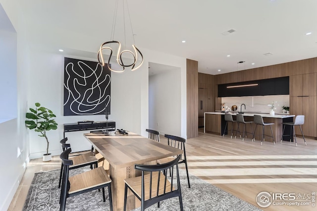 dining room featuring a chandelier and light wood-type flooring