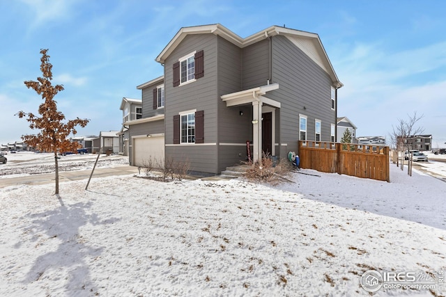 view of front of house featuring a garage and fence