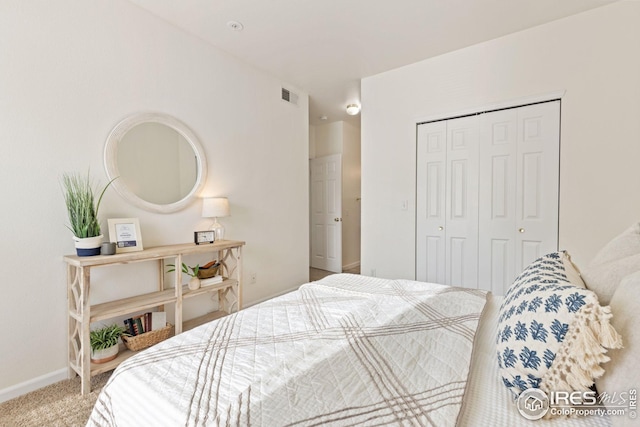 bedroom with carpet floors, a closet, visible vents, and baseboards