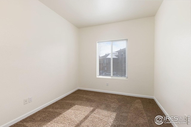 empty room with carpet floors and baseboards