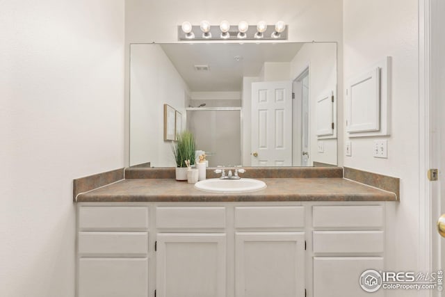 full bath with visible vents, a stall shower, and vanity
