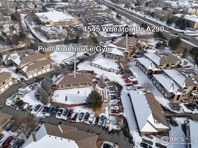 snowy aerial view with a residential view