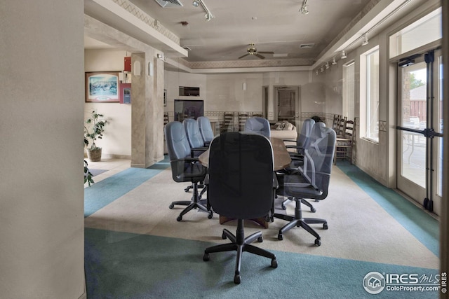 office area with carpet, a raised ceiling, and track lighting