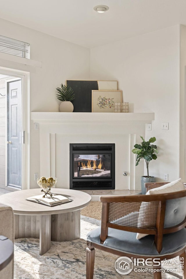 sitting room with a glass covered fireplace