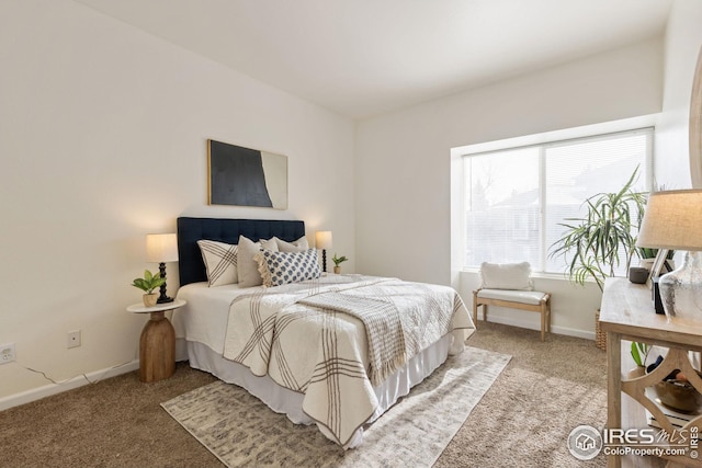 bedroom featuring light carpet and baseboards