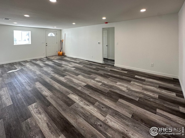 interior space with recessed lighting, visible vents, baseboards, and dark wood finished floors