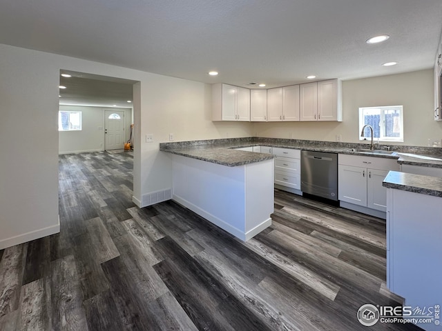 kitchen featuring white cabinets, dark wood-type flooring, a healthy amount of sunlight, and stainless steel dishwasher