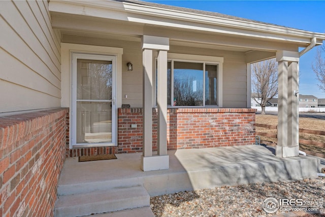 entrance to property featuring a porch