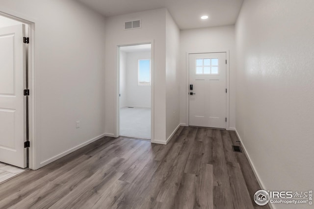 doorway with hardwood / wood-style flooring