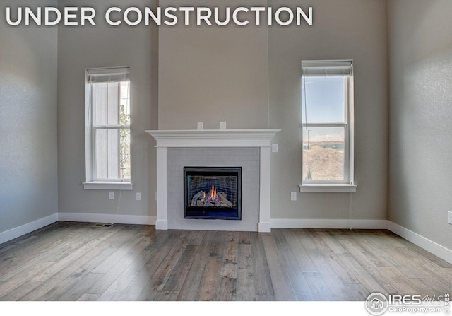 unfurnished living room with light hardwood / wood-style flooring and a fireplace