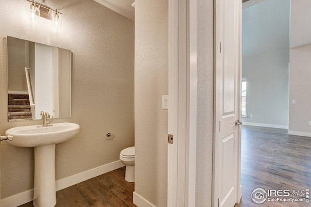 bathroom with sink, toilet, and hardwood / wood-style floors